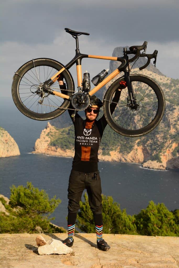 holding a bamboo gravel bike in Mallorca
